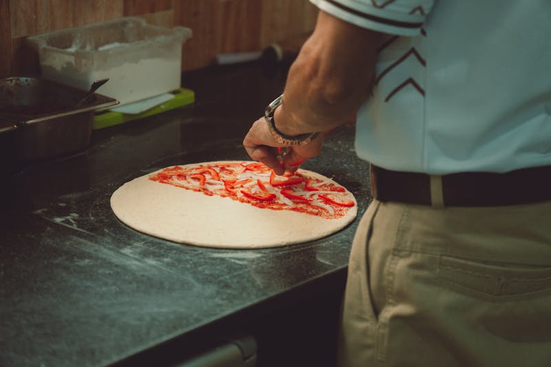 Pizza inn kitchen with fresh pizza being made